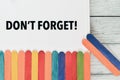 Colorful ice cream sticks and whiteboard written with DON`T FORGET Royalty Free Stock Photo