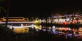 A colorful illuminated bridge over a small river in the Cambodian city of Siem Reap, colorful reflections of night lights on the Royalty Free Stock Photo