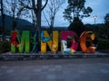 Colorful illuminated welcome sign gateway board name letters in Parque Central de Mindo Ecuador South America