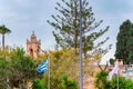 Colorful image of the ancient Ayia NAPA monastery in Ayia NAPA. Monastery tower on the background of the Greek flag. Ayia NAPA,