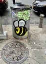 Detail of a garbage bin and a sewer in the New York City neighborhood.