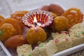 Colorful Indian sweets with a diwali lamp