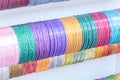 Indian wrist bracelets stacked in piles on display in Little India Singapore