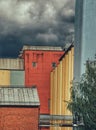 Colorful industrial buildings against storm clouds