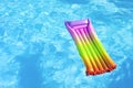 Colorful inflatable mattress floating on the surface of the water. Top view and copy space Royalty Free Stock Photo