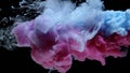 Colorful ink splash into water on black background