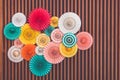 colorful paper fans on wood beams wall