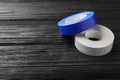 Colorful insulating tapes on black wooden table. Space for text Royalty Free Stock Photo