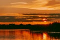 Colorful and intense sunset over the Lielupe river in Latvia during hot summer evening Royalty Free Stock Photo