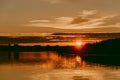 Colorful and intense sunset over the Lielupe river in Latvia during hot summer evening Royalty Free Stock Photo