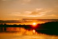 Colorful and intense sunset over the Lielupe river in Latvia during hot summer evening Royalty Free Stock Photo