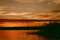 Colorful and intense sunset over the Lielupe river in Latvia during hot summer evening Royalty Free Stock Photo