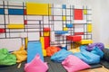 Colorful interior children public playroom with pillows and painted