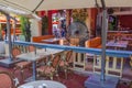 Colorful interior view of restaurant on Ocean Drive, Miami Beach, equipped with misting fan for comfort of guests. Royalty Free Stock Photo