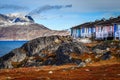 Colorful Inuit houses among the rocks and heavy stones with Sermitsiaq mountain in the background in Nuuk, Greenland Royalty Free Stock Photo