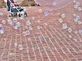 Colorful, iridescent, big soap bubbles are floating