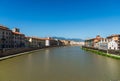 Colorful Italian houses in Pisa, Italy, alongside the embankment of Arno river.