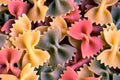 Colorful italian pasta farfalle tricolore abstract backdrop.