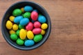Colorful jelly beans candies in a bowl on wooden background. Sweet holiday treats for kids