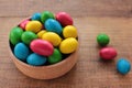 Colorful jelly beans candies in a bowl on wooden background. Sweet holiday treats for kids Royalty Free Stock Photo