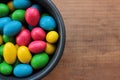 Colorful jelly beans candies in a bowl on wooden background. Sweet holiday treats for kids