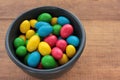 Colorful jelly beans candies in a bowl on wooden background. Sweet holiday treats for kids