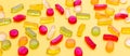 Colorful jelly candies assortment on yellow color background, closeup view Royalty Free Stock Photo