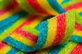 Colorful jelly candies strips in sugar sprinkles. Sour flavored rainbow candy background Royalty Free Stock Photo