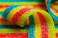 Colorful jelly candies strips in sugar sprinkles. Sour flavored rainbow candy background Royalty Free Stock Photo