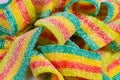 Colorful jelly candies strips in sugar sprinkles. Sour flavored rainbow candy background Royalty Free Stock Photo