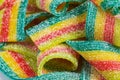 Colorful jelly candies strips in sugar sprinkles. Sour flavored rainbow candy background Royalty Free Stock Photo