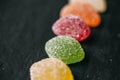 Colorful jelly candies with sugar on black slate background. Close up view of fruity jelly candies as texture. Royalty Free Stock Photo