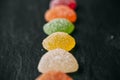 Colorful jelly candies with sugar on black slate background. Close up view of fruity jelly candies as texture. Royalty Free Stock Photo