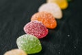 Colorful jelly candies with sugar on black slate background. Close up view of fruity jelly candies as texture. Royalty Free Stock Photo
