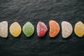 Colorful jelly candies with sugar on black slate background. Close up view of fruity jelly candies as texture. Royalty Free Stock Photo