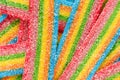 Colorful jelly candies in sugar sprinkles. Sour flavored rainbow candy background. Royalty Free Stock Photo