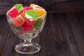 Colorful jelly candy in a glass vase on wooden background Royalty Free Stock Photo