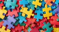 Colorful jigsaw puzzle pieces scattered on a flat surface. Autistic Pride Day