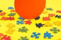 Colorful jigsaw puzzle pieces on yellow background with one piece missing Royalty Free Stock Photo