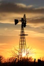 Colorful Kansas Sunset in the evening with clouds and a Windmill silhouette. Royalty Free Stock Photo
