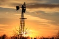 Colorful Kansas Sunset in the evening with clouds and a Windmill silhouette. Royalty Free Stock Photo