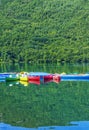 Colorful kayak boats resting on the lake in a nautical school about to slip from Huesca Spain