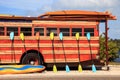 Colorful kayak and paddleboard paddles leaning against a woody style hippy bus