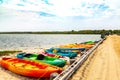 Colorful kayaks along dirt road and ocean in Chappaquiddick on Martha`s Vineyard