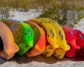 Colorful kayaks on the beach awaiting rental by active people or vacationers