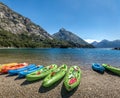 Colorful Kayaks in a lake surrounded by mountains at Bahia Lopez in Circuito Chico - Bariloche, Patagonia, Argentina Royalty Free Stock Photo