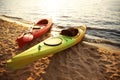 Colorful kayaks near water on river beach at sunset. Summer camp activity Royalty Free Stock Photo