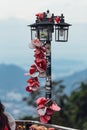 Colorful keychain holded on post lamp is called `Love Lock Penang Hill` from Penang Hill at George Town. Penang, Malaysia