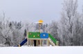 Kids playground on a snowy winter day. Royalty Free Stock Photo
