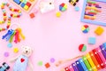 Colorful kids toys on pink background. Top view Royalty Free Stock Photo